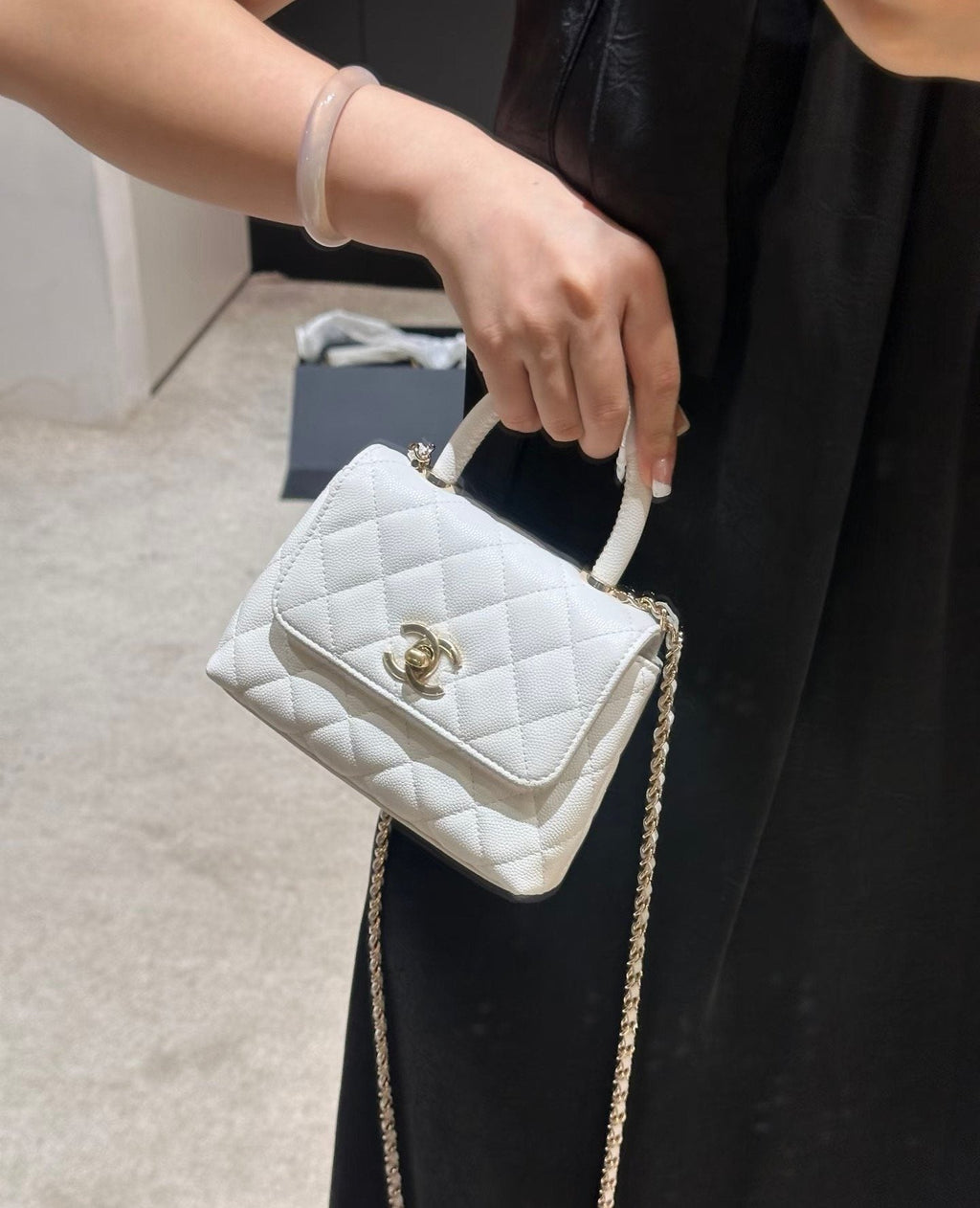 Chanel Diamond-Quilted Top-Handle Flap Bag — model