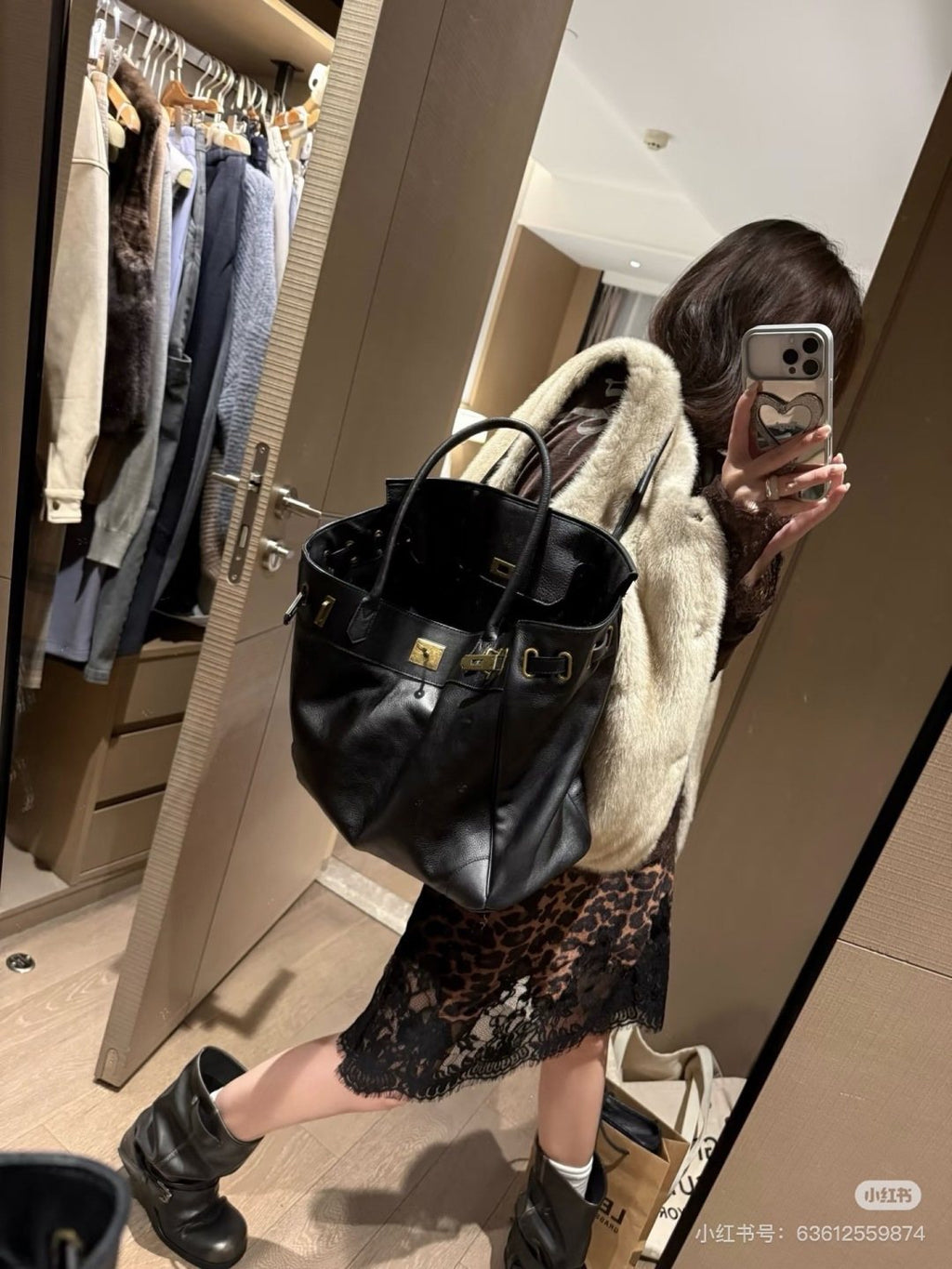 Black Folded-Flap Handbag with Gold-Tone Hardware — model