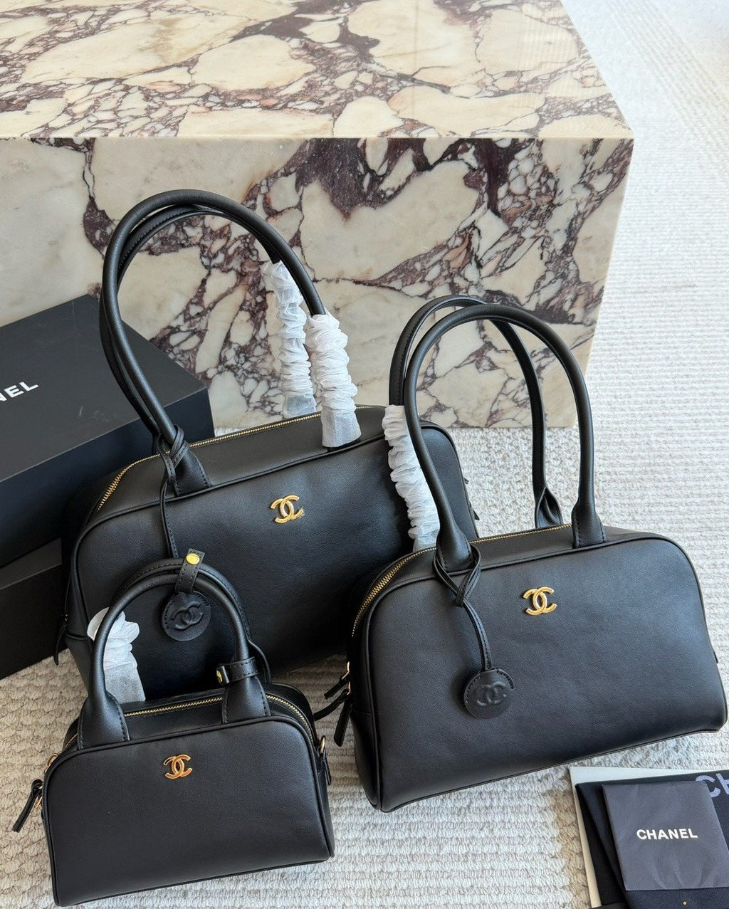 Chanel Black Bowling Bag with Round Charm — comparison